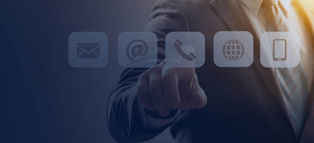 A businessman in a suit points at contact icons: email, at symbol, phone, globe, and smartphone, symbolizing communication options.