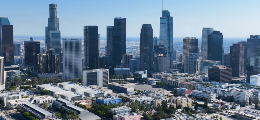 A view featuring modern skyscrapers and urban structures against a clear blue sky.