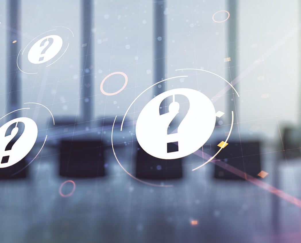 Abstract image featuring question marks floating against a blurred background of a meeting room, symbolizing inquiry and discussion.