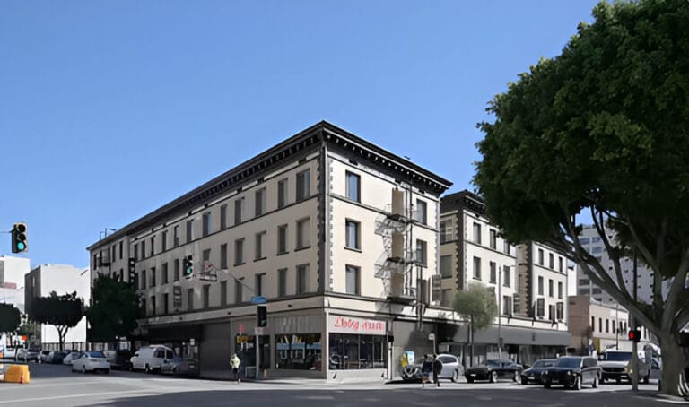 A building stands at the corner of a street, showcasing its architecture against the urban backdrop.