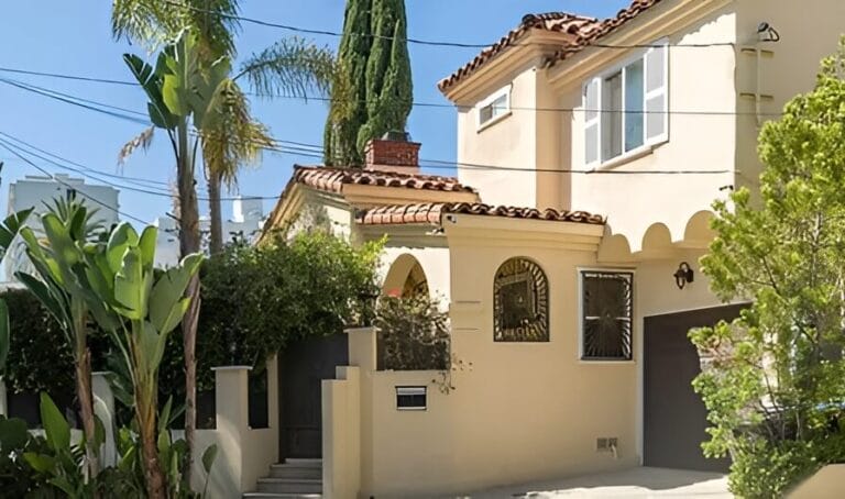 A house featuring a garage and a paved driveway, set in a residential neighborhood.