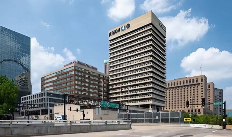 A large building with a prominent sign displayed in front, indicating its purpose or name.