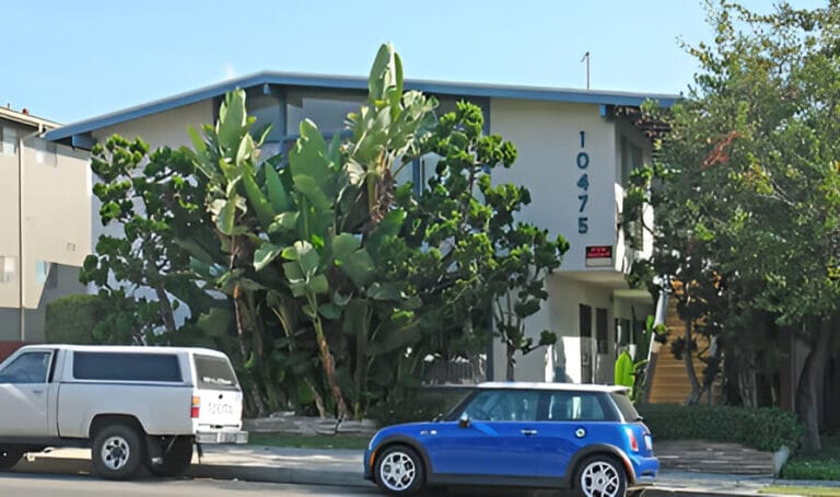 A modern building and cars parked outside.