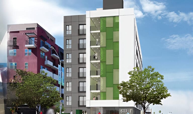 A modern building featuring green and white panels, showcasing a contemporary architectural design.