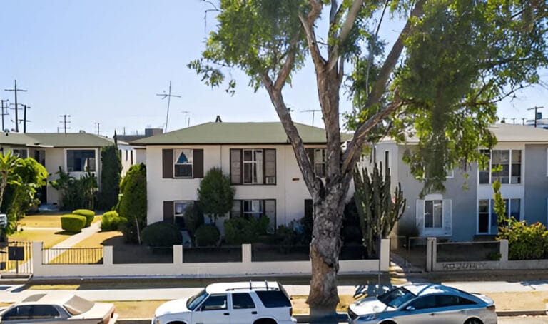 A residential house and several cars parked in front of it.