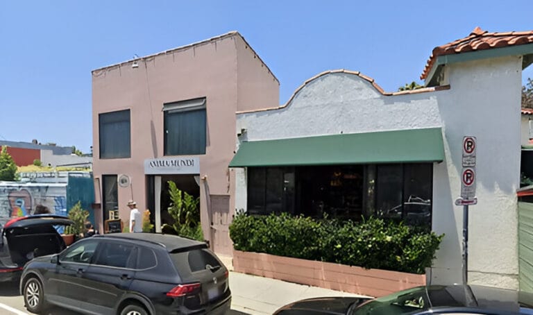 A retail building and a car parked in front of it.