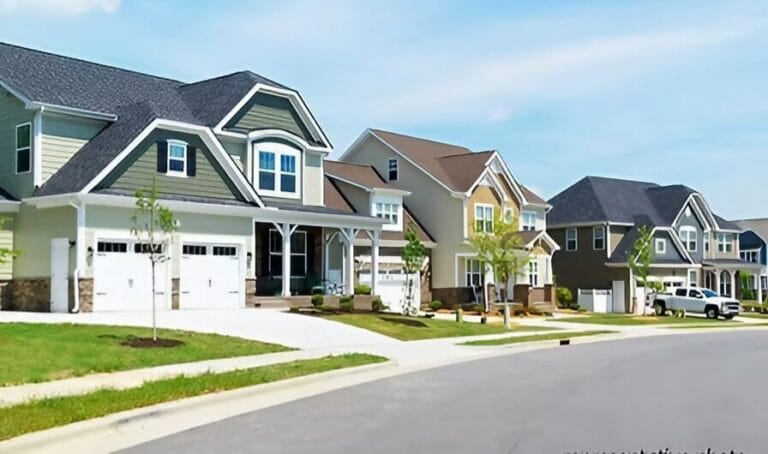 A row of houses lined up in a quiet residential neighborhood, showcasing various architectural styles and colors.