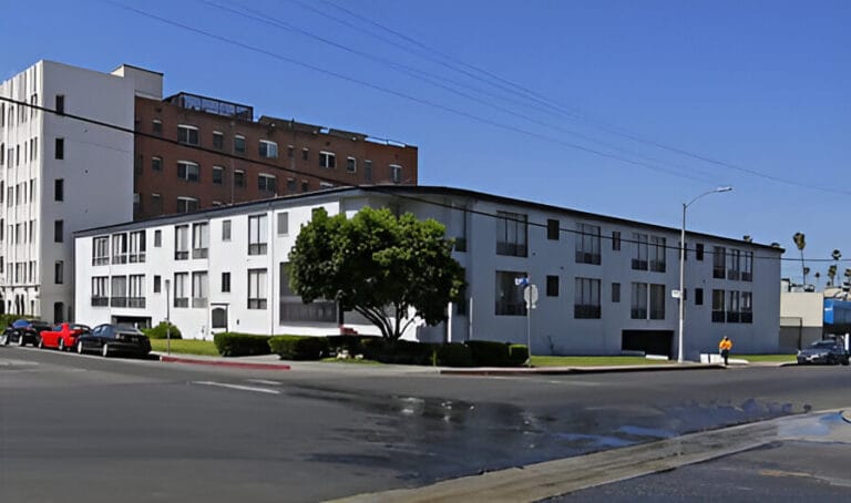 A white building featuring numerous windows, showcasing a modern architectural design.
