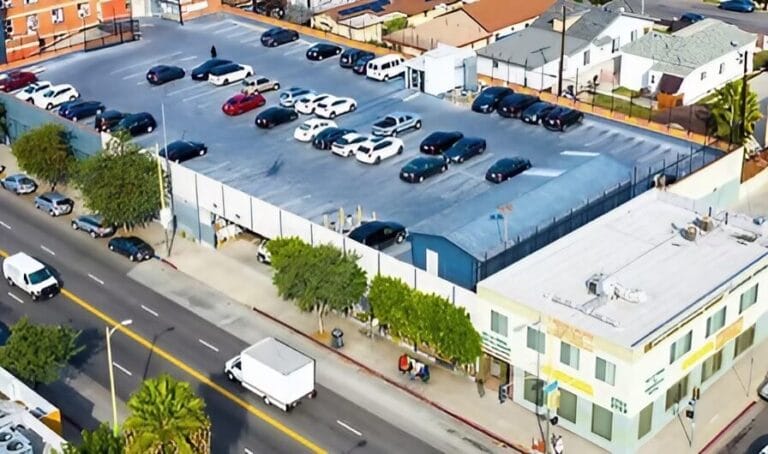 Aerial view of a parking lot filled with various cars parked in neat rows