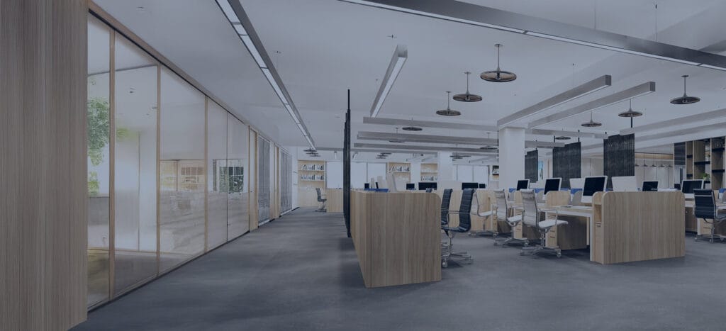 Modern office interior featuring sleek furniture, large windows, and multiple workstations arranged in an open layout.